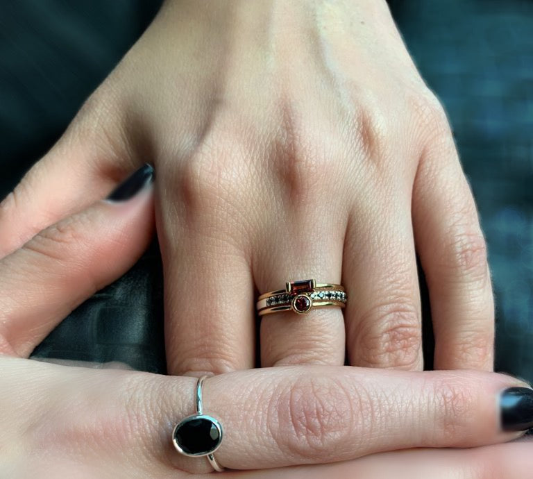 Fine gold stack rings with red garnet