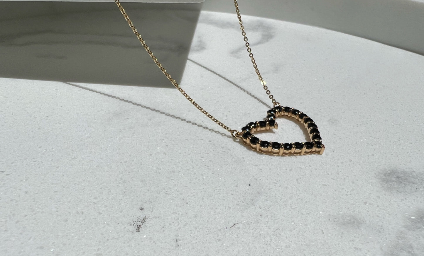 Gold and black onyx heart necklace