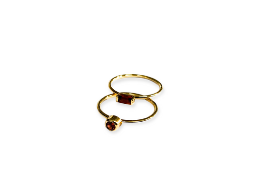 Fine gold stack rings with red garnet